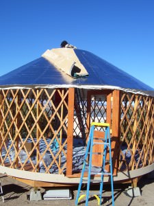 100_1240 Wooden yurt frame beneath its roof cover