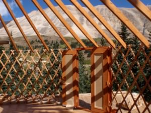 Lattice, rafters, door Wooden lattice wall and roof rafters inside a yurt