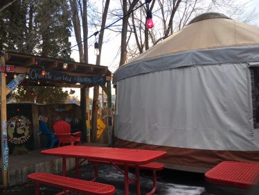 Yurt beside outdoor seating