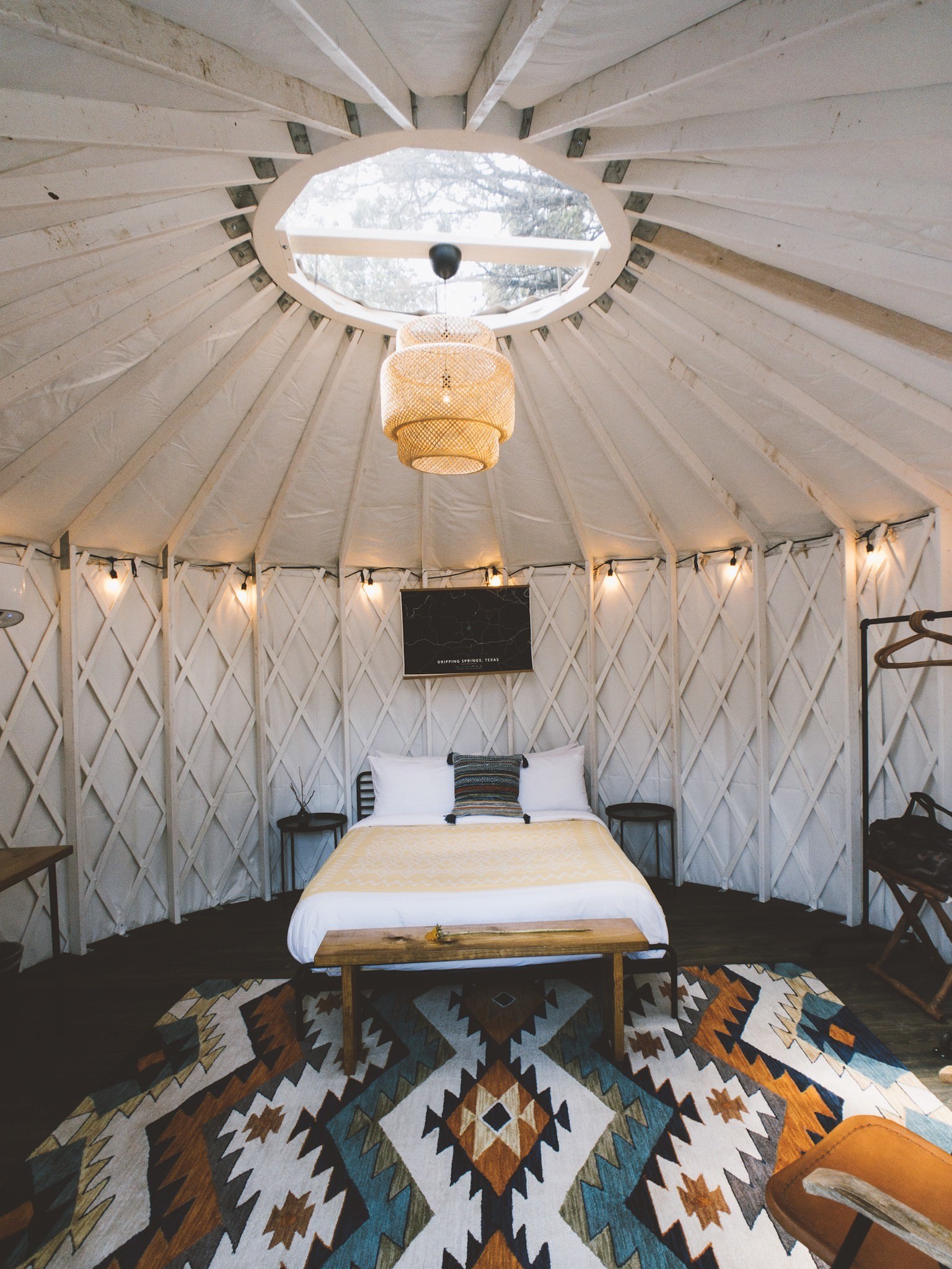 Yurt bedroom beneath a dome skylight