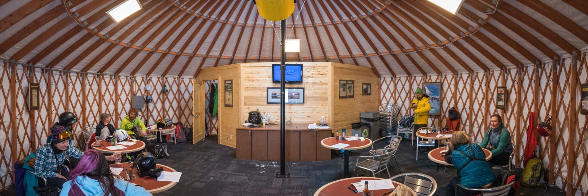 People seated inside a lodge yurt