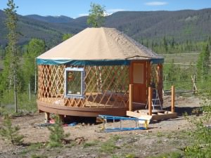 YMCA OF THE ROCKIES Yurt frame under construction on a wooden platform