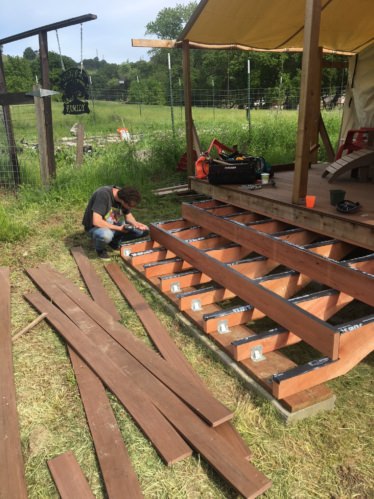 Person working on a wooden deck
