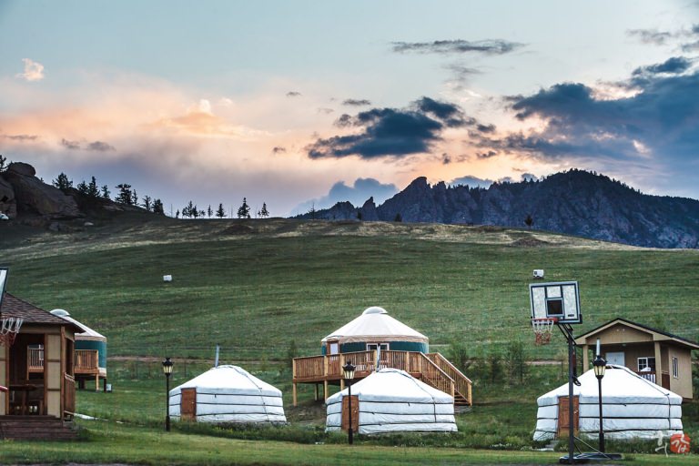 Yurts beside a lake at dusk