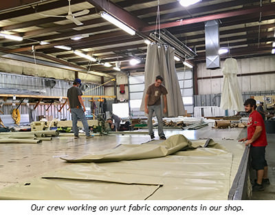 Workers cutting and handling fabric in the workshop