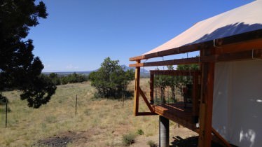 Yurt deck overlooking trees and open land