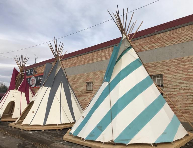 Striped painted tipi beside a building