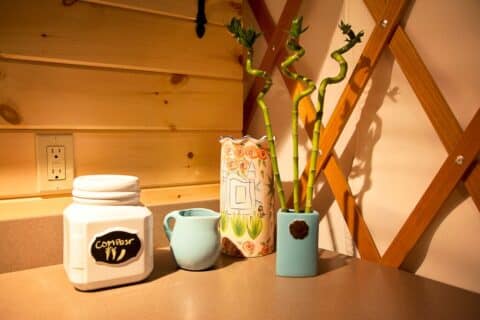 Kitchen shelf and flowers inside a yurt
