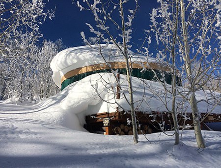 Yurt surrounded by deep snow