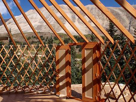 Wooden lattice wall and rafters during assembly