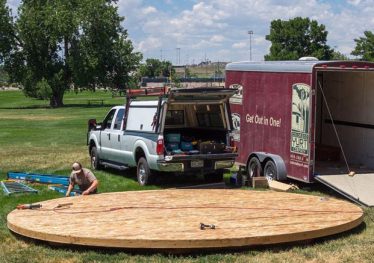Circular yurt platform beside a delivery truck