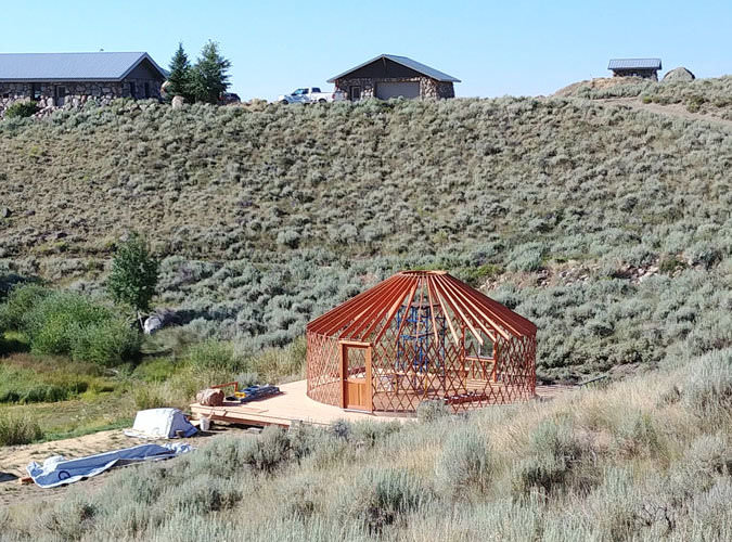 Partially built yurt in open countryside